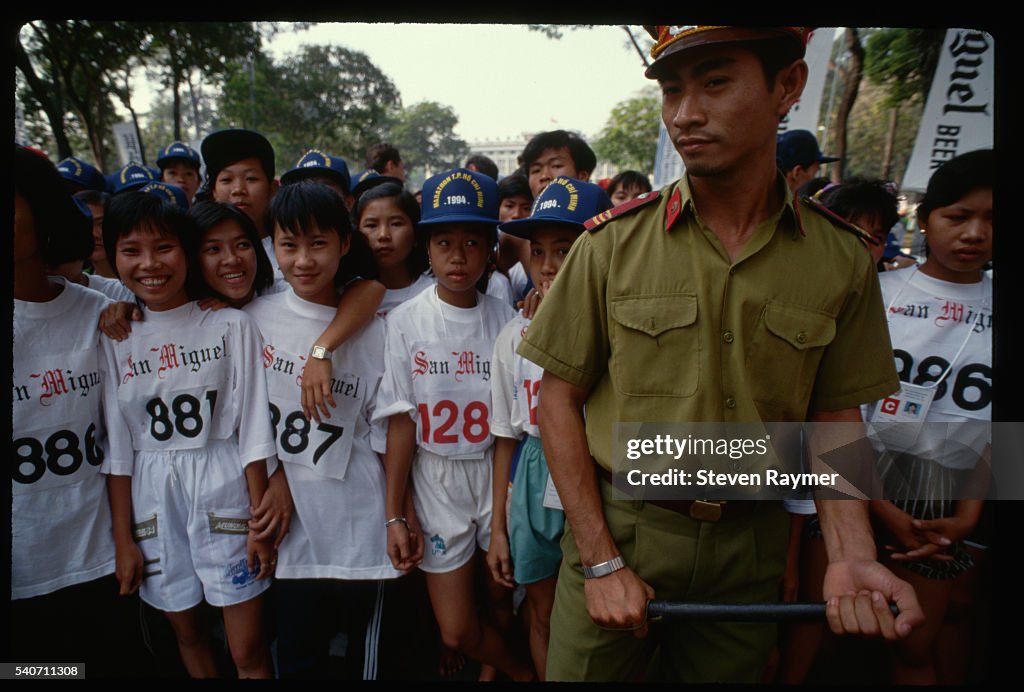 Policeman Holds Back Marathon Runners