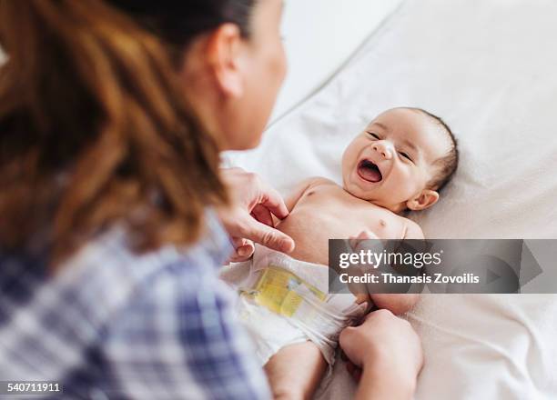 mother with her newborn child - attrezzatura per neonato foto e immagini stock