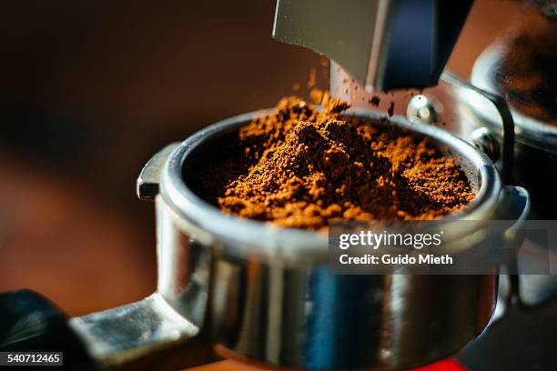 grinding fresh espresso beans. - moler fotografías e imágenes de stock
