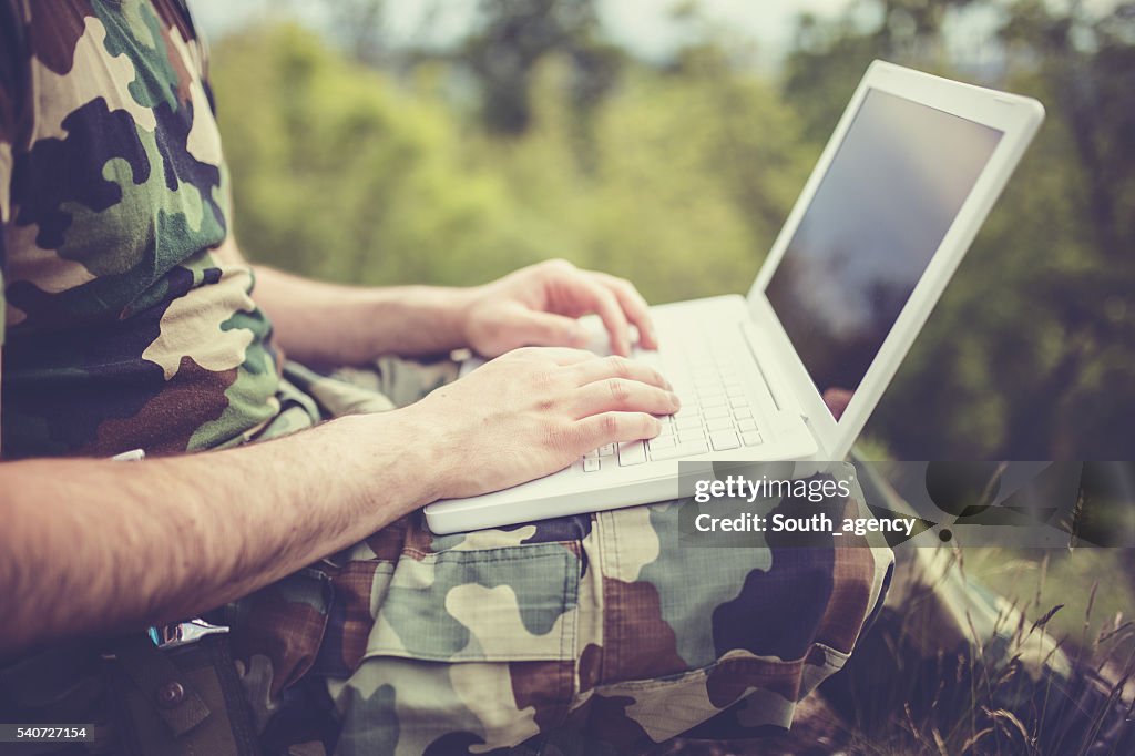 Army man working on laptop