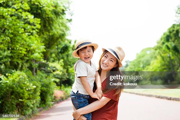 parents and children are happily laughing at park - trip hazard stock pictures, royalty-free photos & images