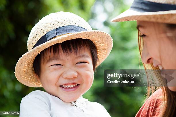 children laughing in mother's arms - trip hazard stock pictures, royalty-free photos & images