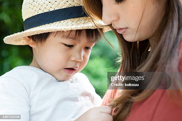 children who are in the mother's arms - trip hazard stock pictures, royalty-free photos & images