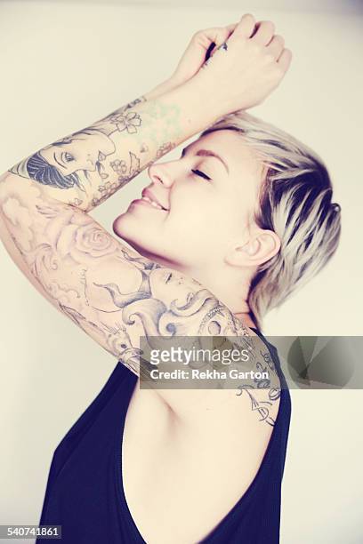 tattooed woman smiling - rekha garton stock pictures, royalty-free photos & images