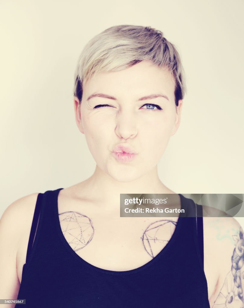 Tattooed woman pulling a funny face