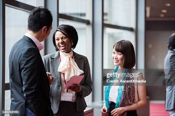 business team consulting in the foyer at a conference - professionals speaking outside stock pictures, royalty-free photos & images