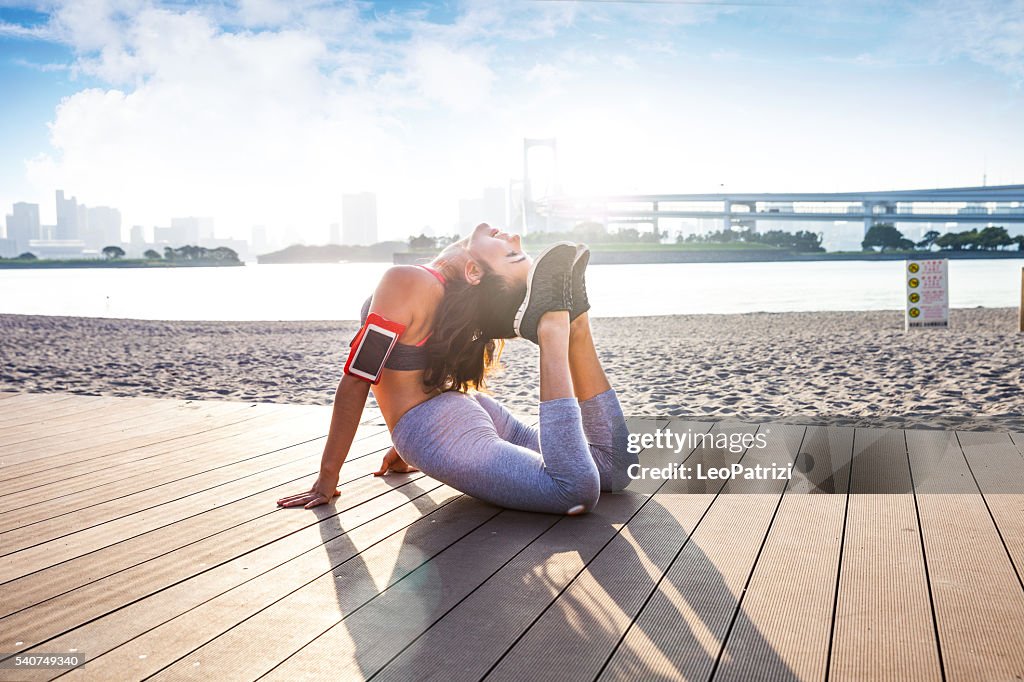 Womam doing Yoga exercises in Tokyo park