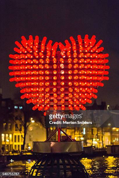 heart shaped light installation - installationskunst stock-fotos und bilder