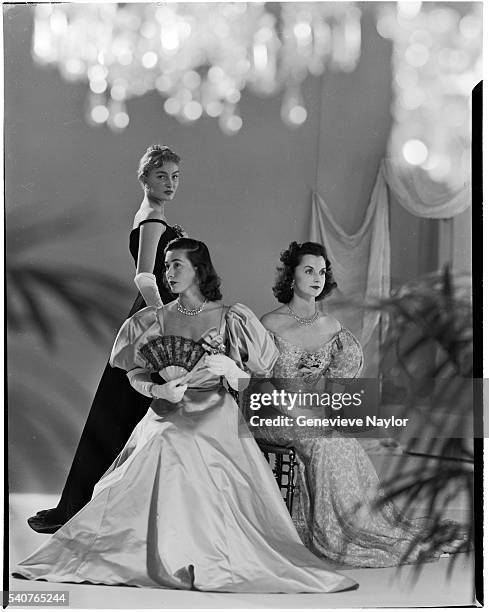 Pamela Curran, Jeanne Murray, and Mrs. Vanderbilt model evening wear for the fiftieth anniversary of the Gibson Ball in 1948.