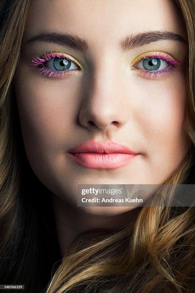 Close up of teenage girl with colorful make up.