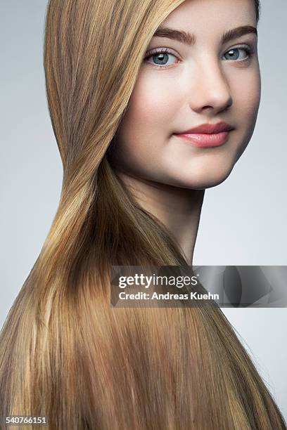 teenage girl with shiny hair over her shoulder. - shiny straight hair stock pictures, royalty-free photos & images