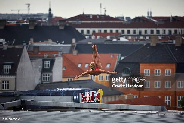 In this handout image provided by Red Bull, Kris Kolanus of Poland dives from the 28 metre platform on the Copenhagen Opera House during the first...
