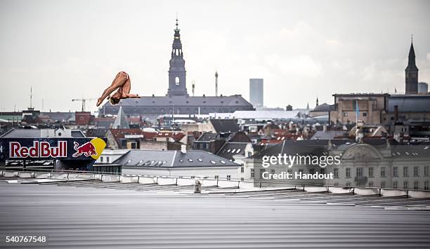 In this handout image provided by Red Bull, Kris Kolanus of Poland dives from the 28 metre platform on the Copenhagen Opera House during the first...