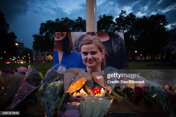 Flowers surround a picture of Jo Cox during a vigil in Parliament Square on June 16, 2016 in London, United Kingdom. Jo Cox Labour MP for Batley and...