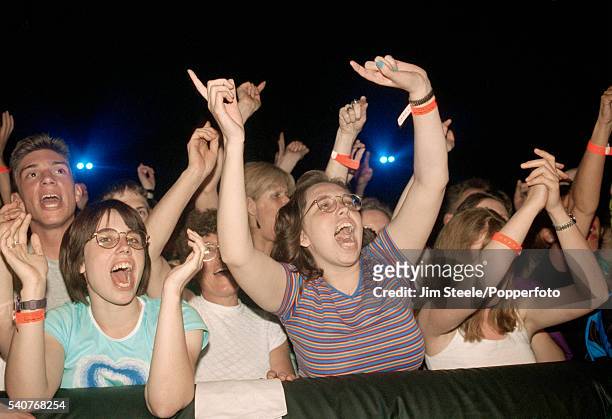 Fans during a concert at Wembley Arena, circa 1990.