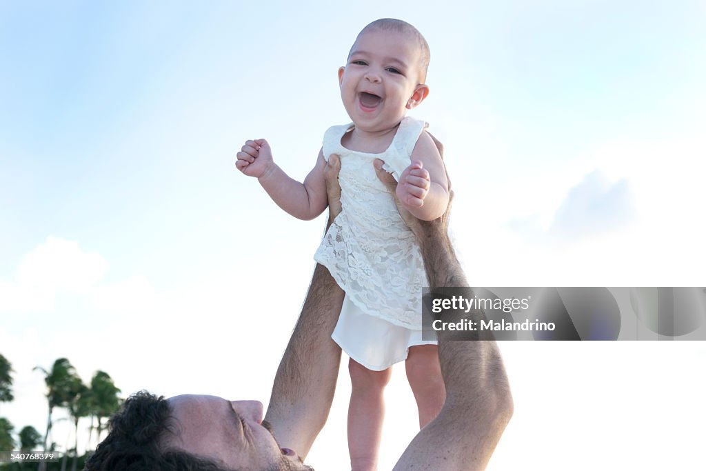 Father lifting a baby