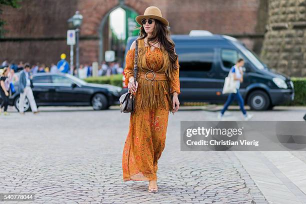 Michaela Janska wearing a boho Zara dress, hat, Louis Vuitton bag during Pitti Uomo 90 on June 16 in Florence, Italy
