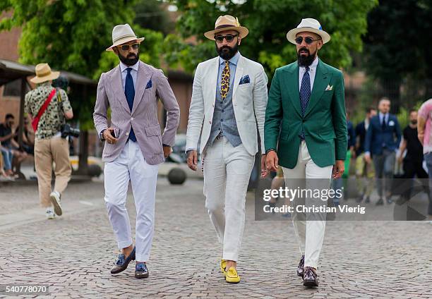 Guests wearing white pants and blazer during Pitti Uomo 90 on June 16 in Florence, Italy