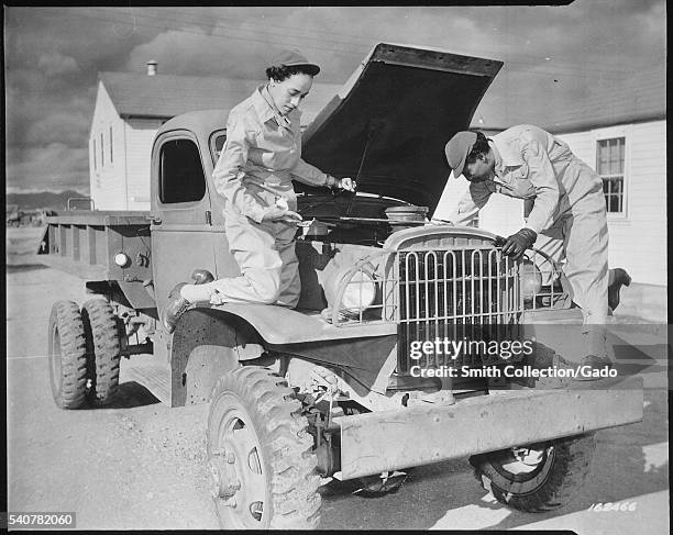 Female auxiliaries Ruth Wade and Lucille Mayo further demonstrate their ability to service trucks as taught them during the processing period at Fort...