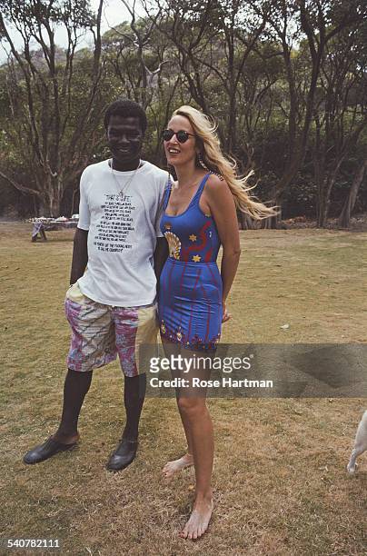 American model Jerry Hall with bar-owner Basil Charles on Mustique, Saint Vincent and the Grenadines, 1995.