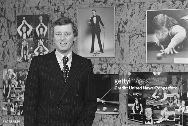 English snooker promoter and manager, Barry Hearn pictured in his office in London on 5th April 1982. Pictures of snooker player Steve Davis hang on...