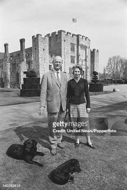 Gavin Astor, 2nd Baron Astor of Hever pictured standing together with his wife, Irene Astor in the grounds of Hever Castle in Kent on 5th April 1982.