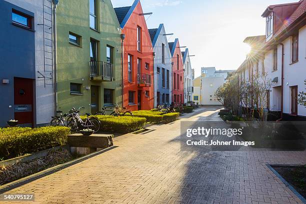 multi colored buildings along footpath - hedge row path stock pictures, royalty-free photos & images