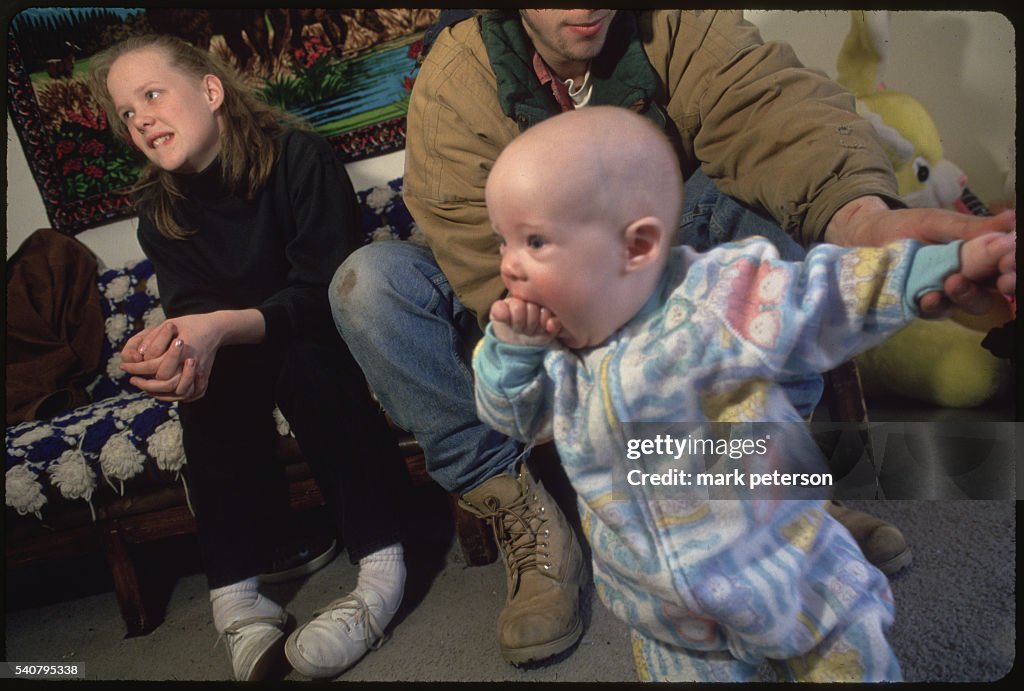 Unwed Teens with Their Infant While Visiting Friends