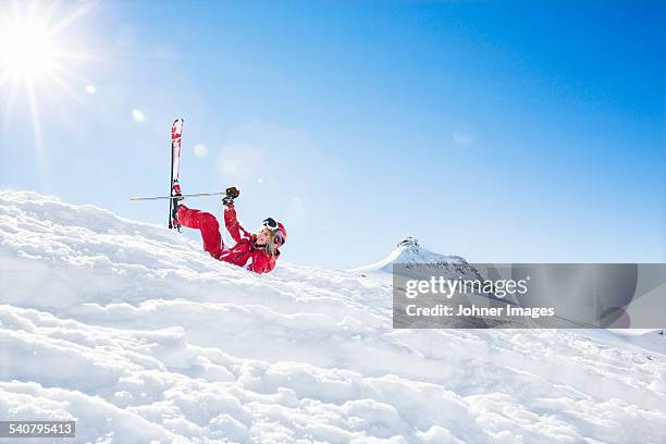 woman falling while skiing - skiing accident stock pictures, royalty-free photos & images