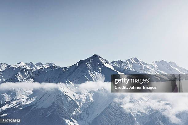 snowcapped mountains - mountain peak through clouds stock pictures, royalty-free photos & images