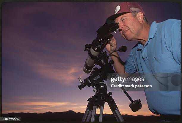 Rachel, Nevada: UFO authority, Chuck Clark, in desert near area 51 with telescope to look for UFO's.
