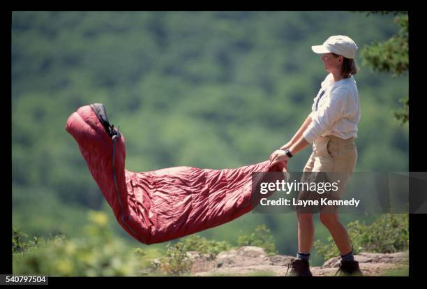 hiker shaking sleeping bag - archival camping stock pictures, royalty-free photos & images