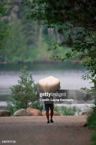 person portaging a canoe - carrying canoe stock pictures, royalty-free photos & images