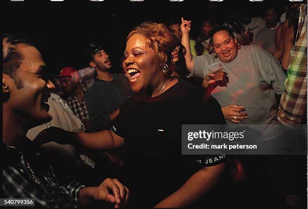 Nightclub goers laugh and dance at Ouary nightclub in the South Bronx, New York.