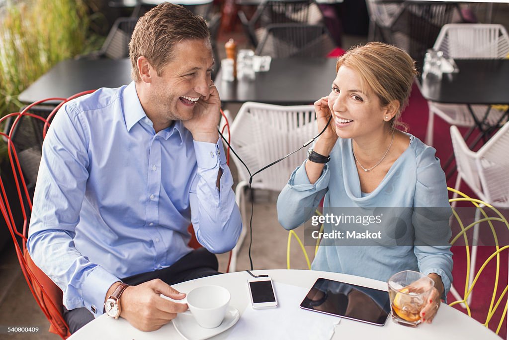 Happy business people taking break in cafe