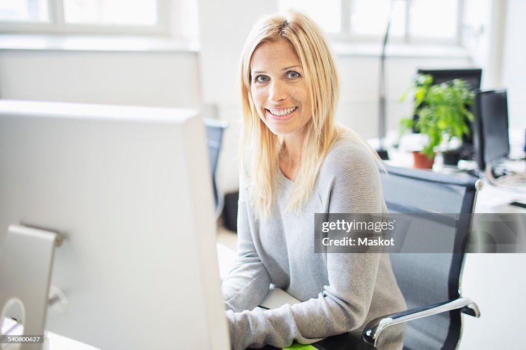 Portrait of smiling businesswoman working in office
