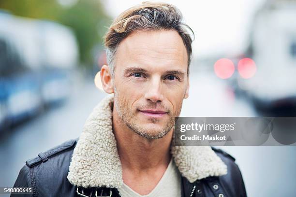 portrait of confident mature man standing on street - hairy men bildbanksfoton och bilder