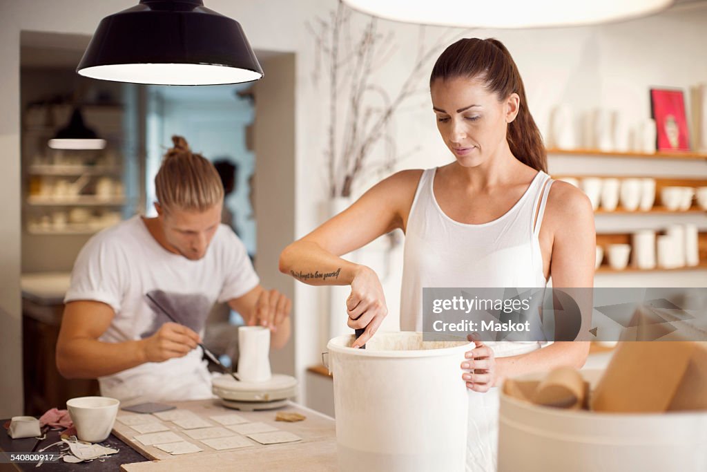 Colleagues working in crockery workshop