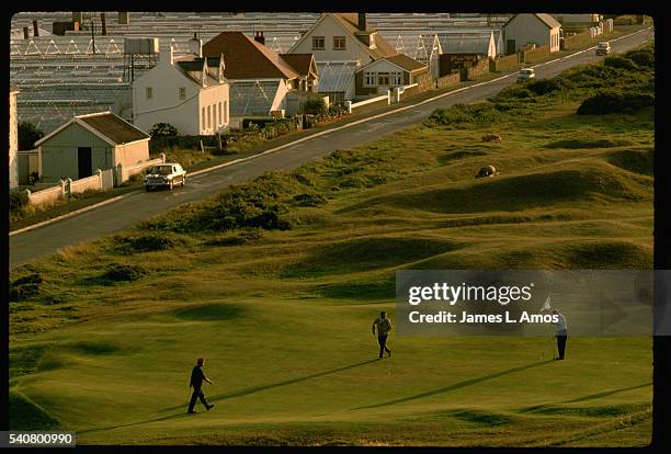 golfers walking on putting green - guernsey stock-fotos und bilder