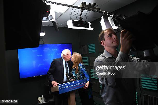 Presidential candidate Bernie Sanders kisses his wife, Jane O'Meara Sanders as he prepares to speak for a video to supporters at Polaris Mediaworks...