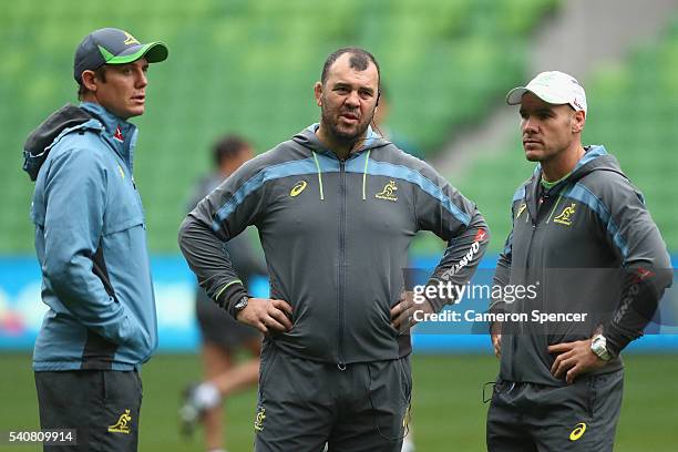 Wallabies coach Michael Cheika talks to assistant coaches Stephen Larkham and Nathan Grey during an Australian Wallabies Captain's Run at AAMI Park...