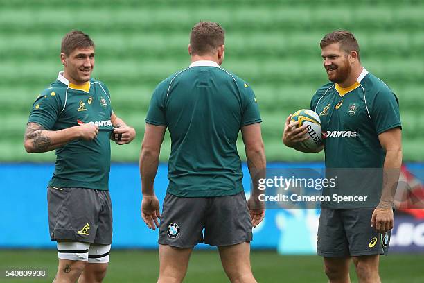 Sean McMahon of the Wallabies talks to team mates James Slipper and Greg Holmes during an Australian Wallabies Captain's Run at AAMI Park on June 17,...