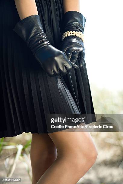 teen girl wearing gloves, hands clasped in front of her, cropped - gloves clasped hands ストックフォトと画像