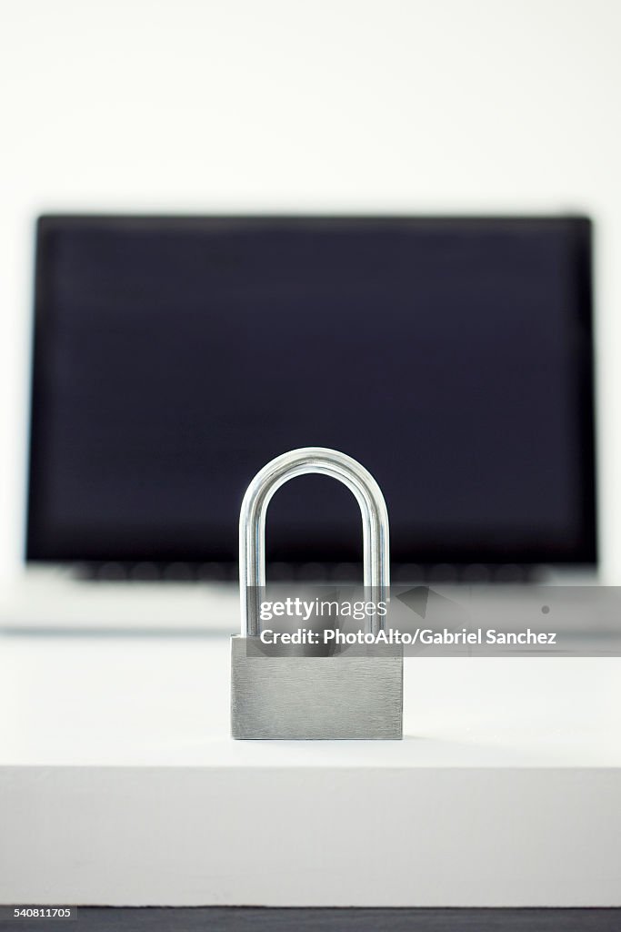 Padlock in front of laptop computer representing internet security