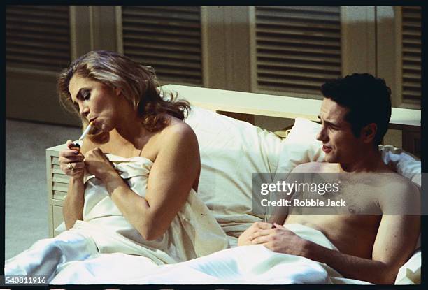 Kathleen Turner in the role of Mrs. Robinson lights a cigarette next to Matthew Rhys, who plays Benjamin Braddock in Terry Johnson's stage adaptation...