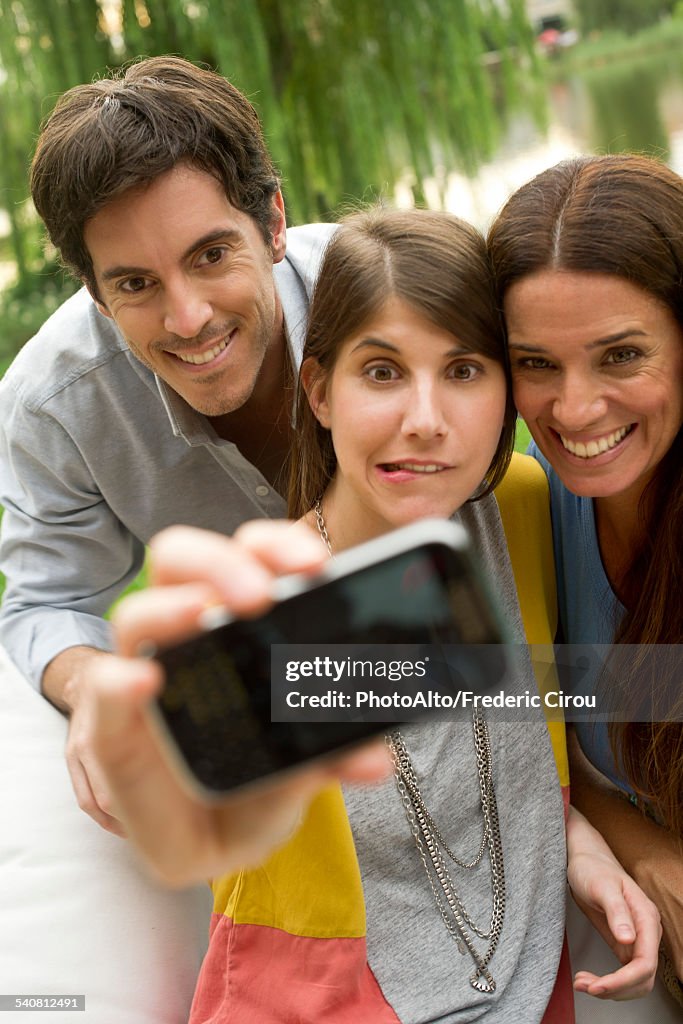 Young woman taking selfie with parents