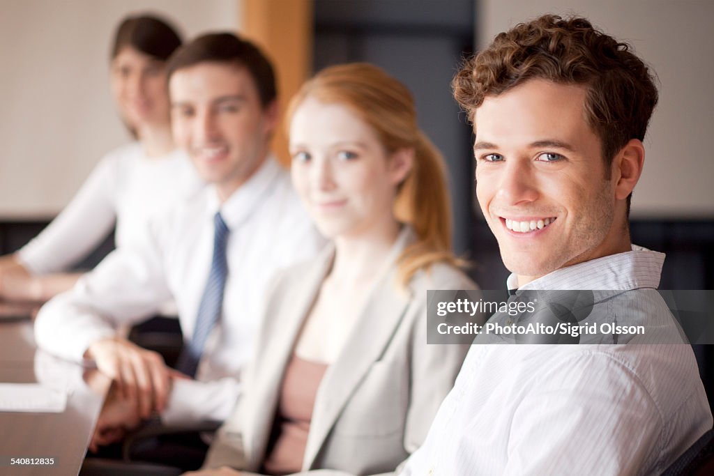 Young business professionals seated in conference room