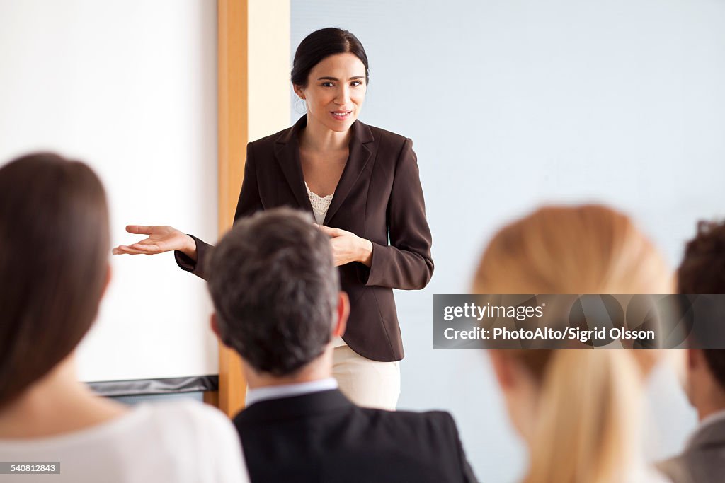 Businesswoman giving presentation at meeting
