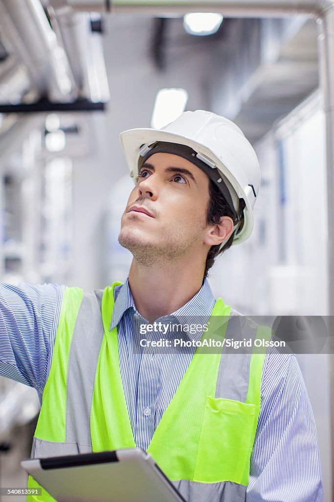 Technician inspecting industrial plant