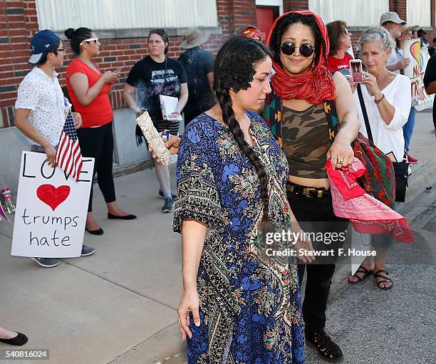 Reivin Alexandria of Dallas, Texas uses burning sage to cleanse Alexis Estrada of Arlington, Texas during a protest outside a rally for Republican...